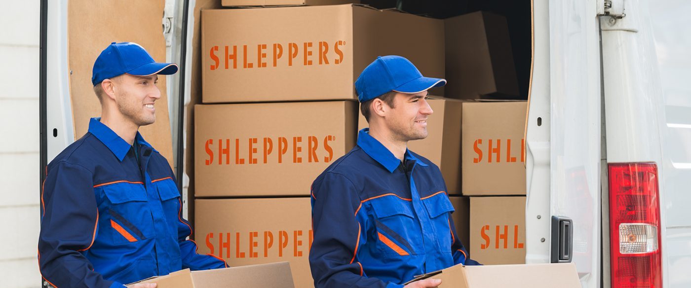 Two movers from an NYC full service moving company, Shleppers, loading boxes into a van.
