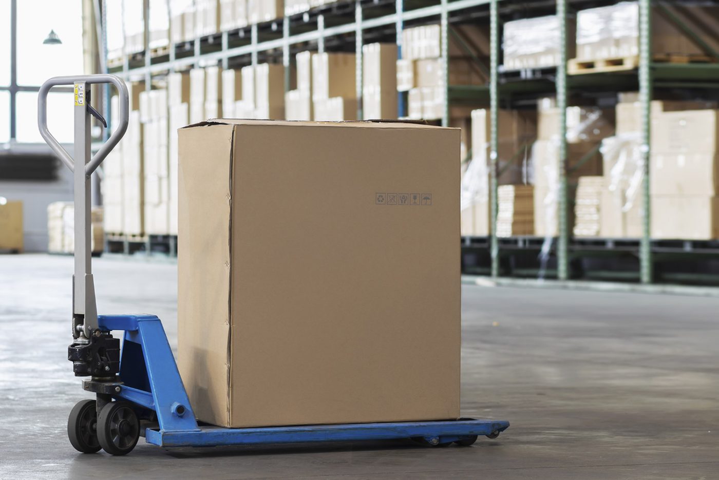 Warehouse storage with packed boxes on a pallet jack, showcasing business storage units in NYC.