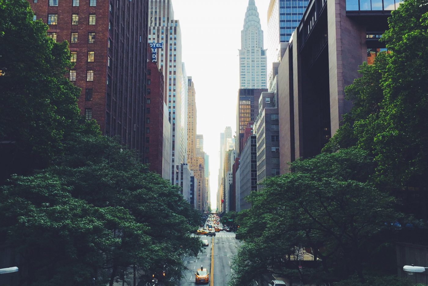 Busy street in NYC with skyscrapers and taxis, representing short distance movers in NYC.