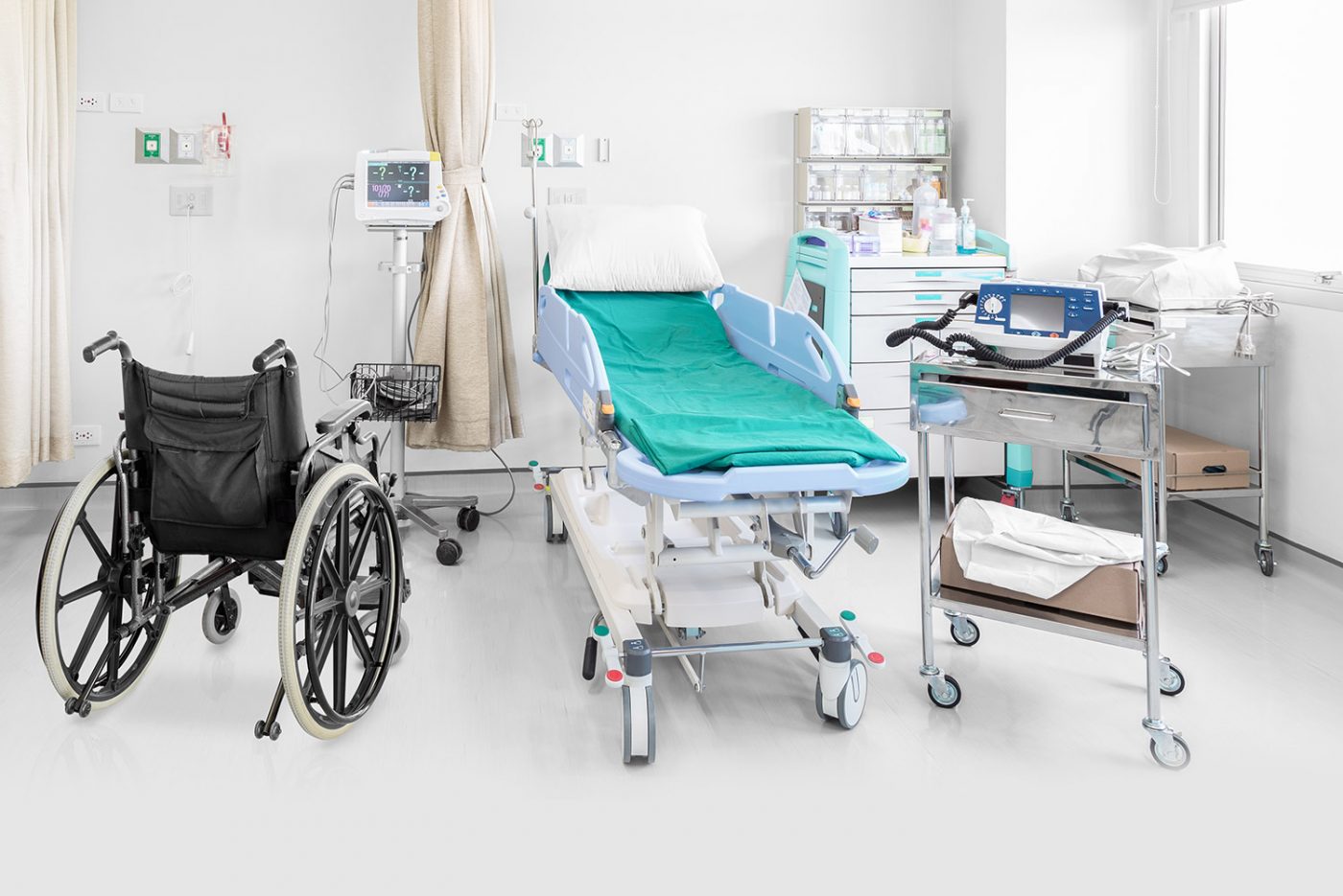 Hospital room with a wheelchair, patient bed, and devices, representing medical equipment moving in NYC.