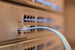 Close-up of an Ethernet cable plugged into a server, representing computer moving services in NYC.