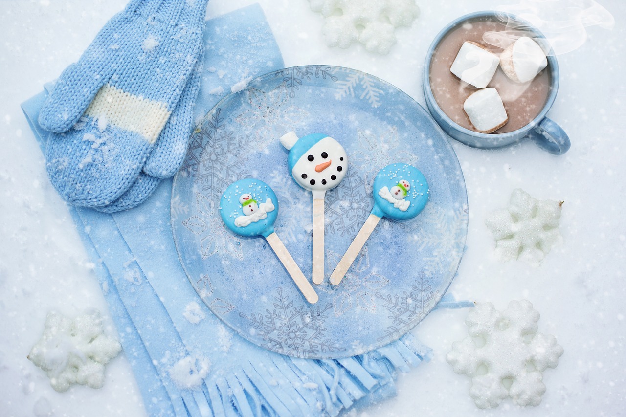 winter gloves, scarf, pops, hot chocolate, and snow