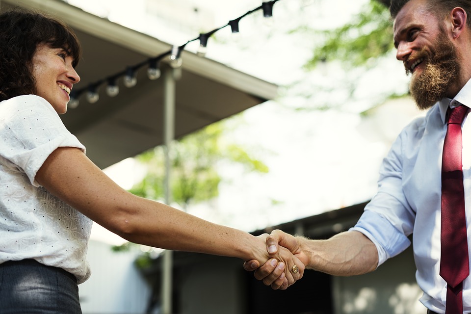 People Smiling and Shaking Hands