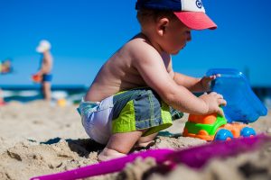 Boy At Beach With Toys