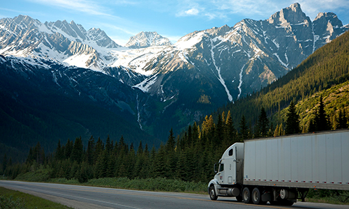 Moving Truck On Road With Mountains