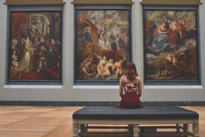 woman sitting in an art museum