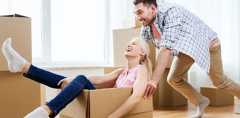 man pushing woman in box on floor