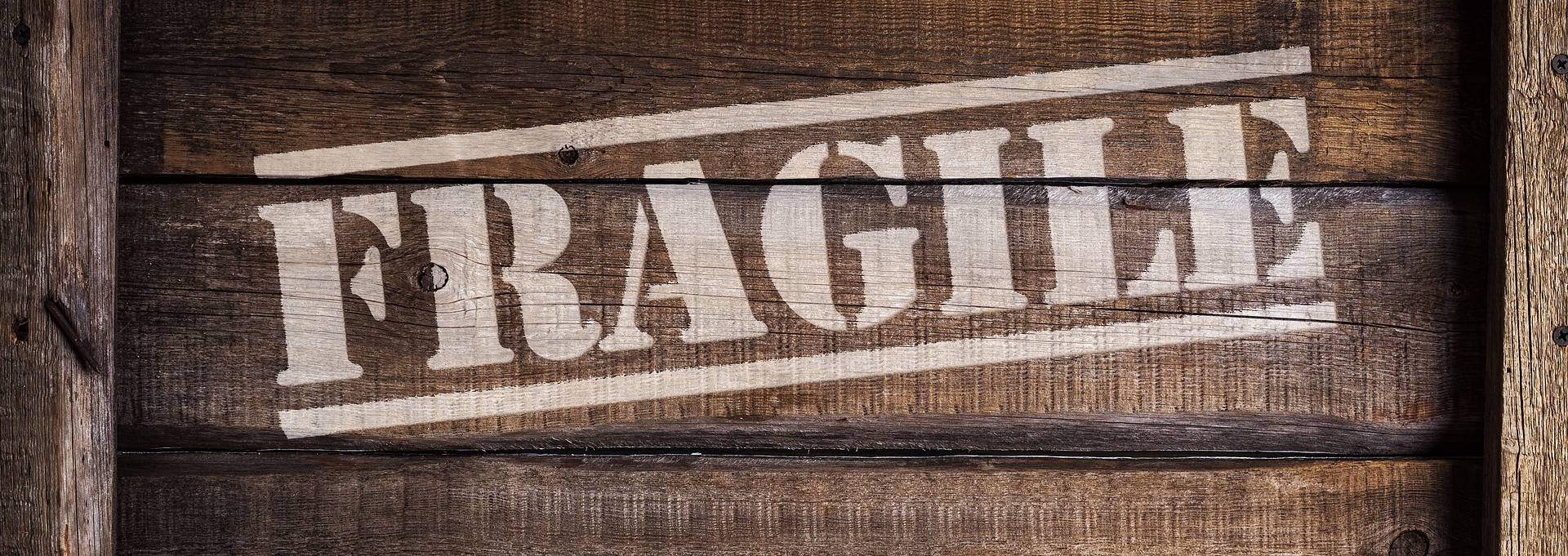 side of a crate with the word fragile stamped on it