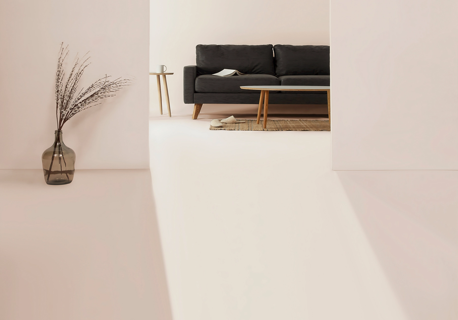 Minimalist living room with a black couch and wooden table, symbolizing getting rid of large furniture when moving.