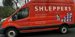 Shleppers Moving & Storage van parked on street, promoting professional services for moving in NYC