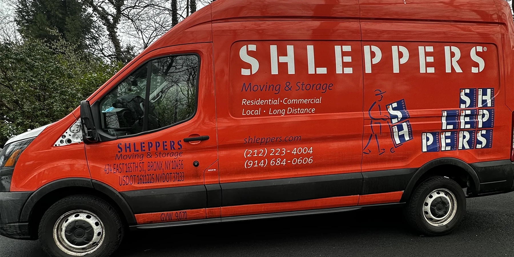 Shleppers Moving & Storage van parked on street, promoting professional services for moving in NYC