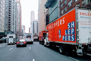 Busy New York street with Shlepper's moving truck