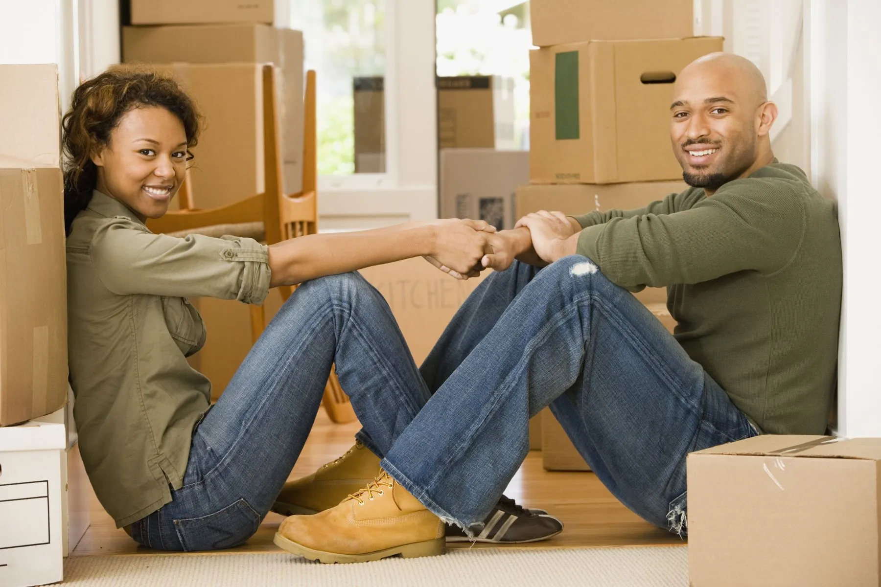 Couple sitting around moving boxes