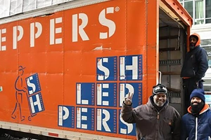 Shleppers movers by moving truck in city
