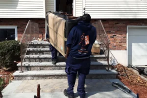 Movers carrying couch up stairs.