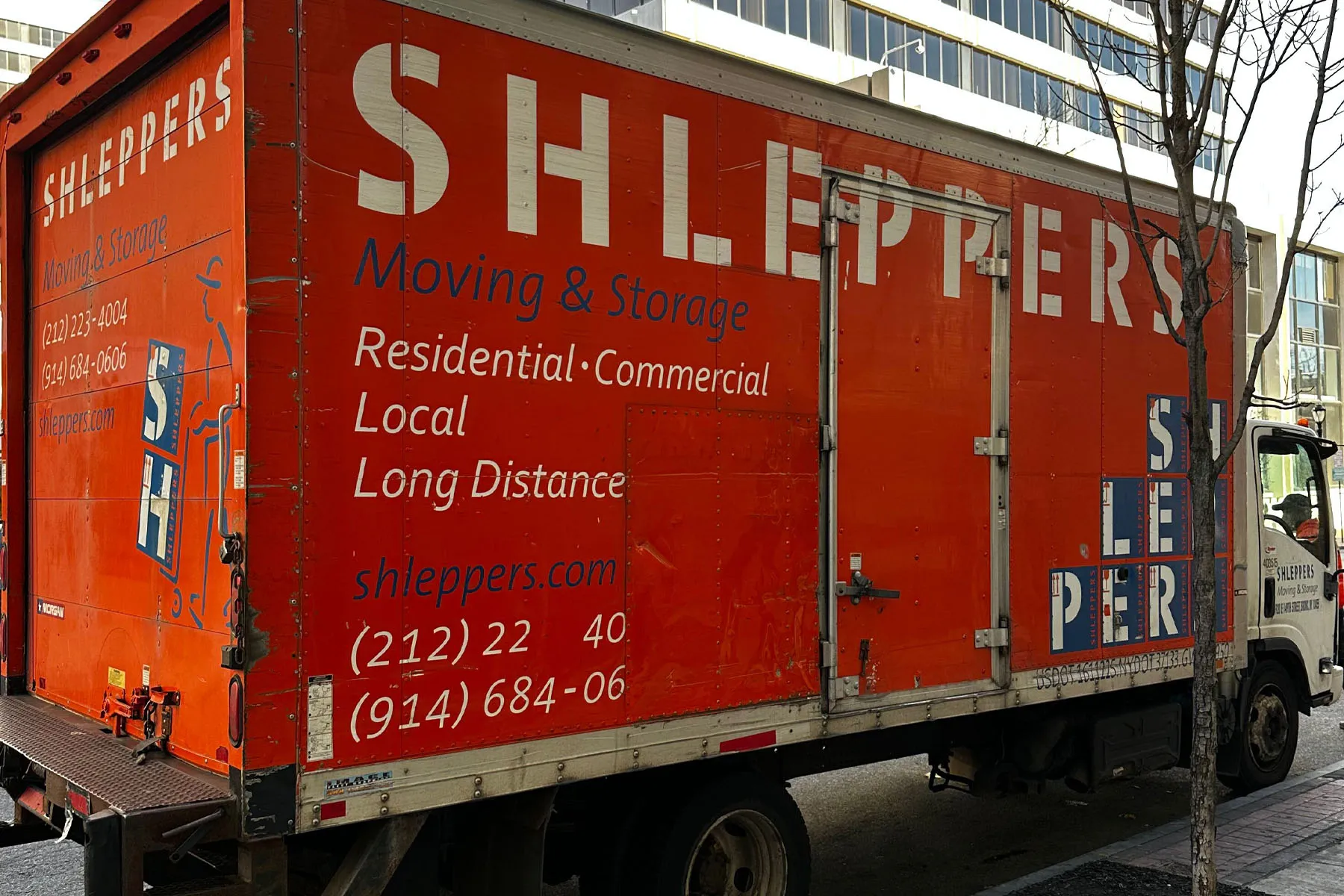 Shleppers movers by moving truck in city