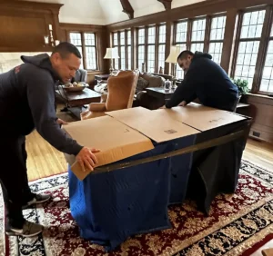 movers packing up a large object