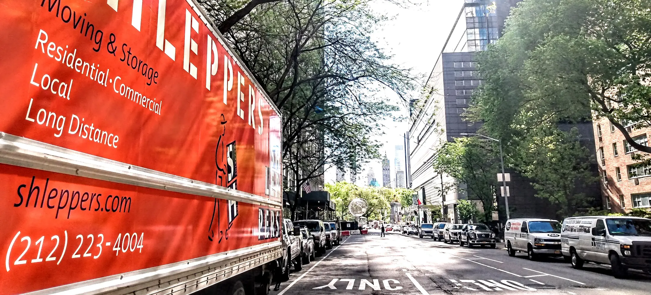 Shleppers moving truck parked on street