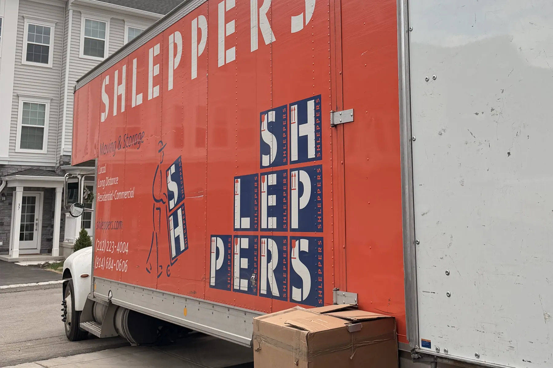 Shleppers moving truck near apartments