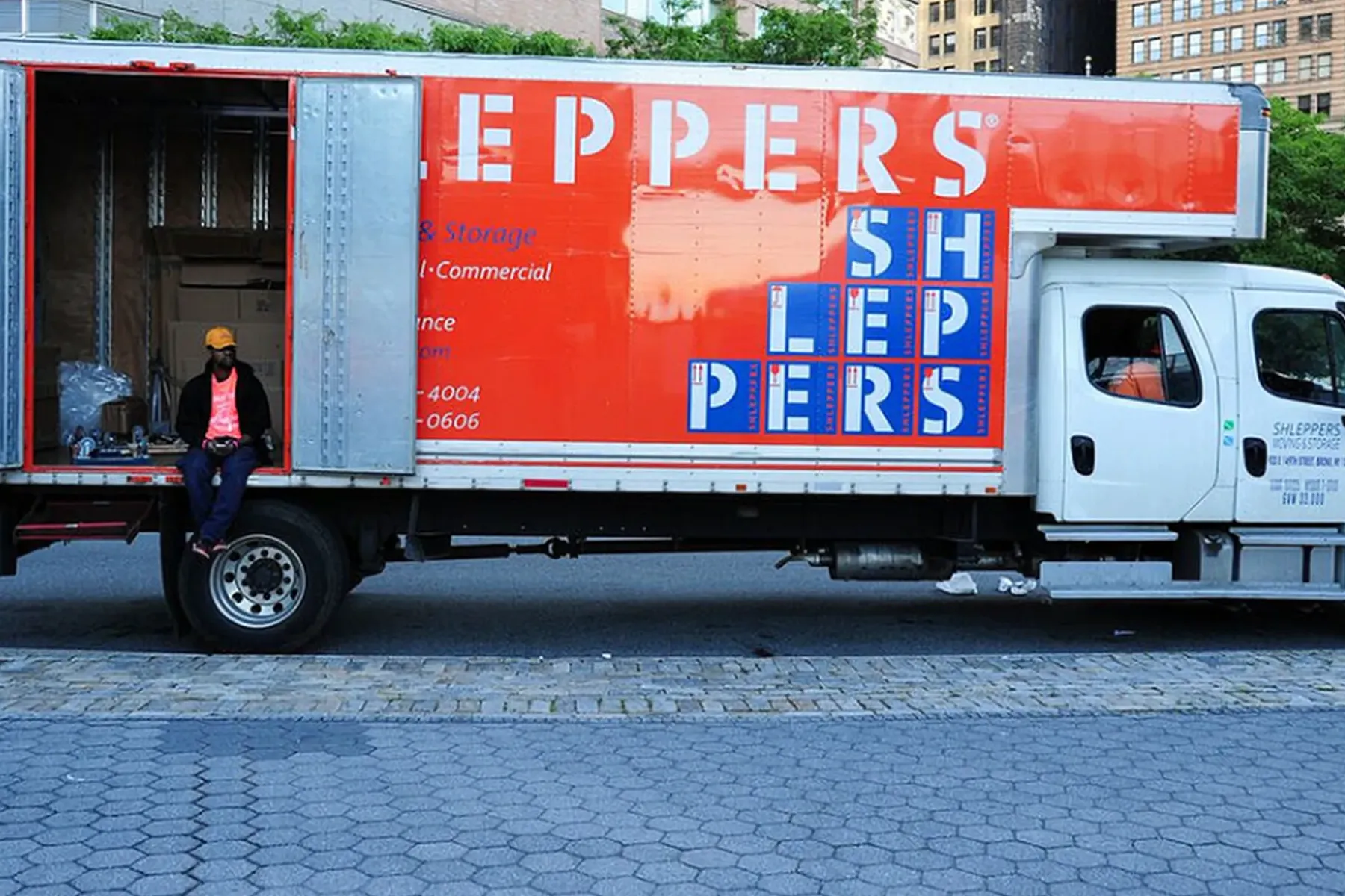 Shleppers moving truck outside downtown