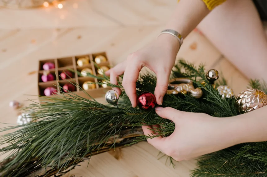 woman's hands creating christmas ornaments and garland